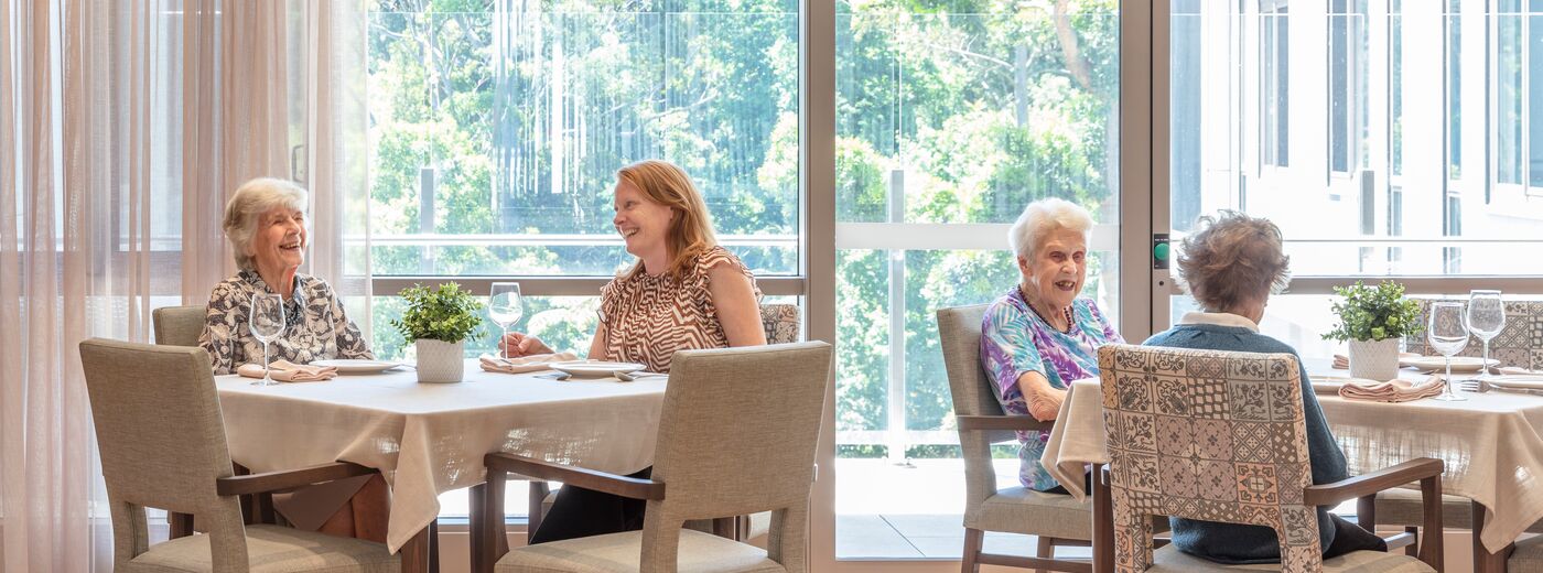 Residents with family enjoying lunch